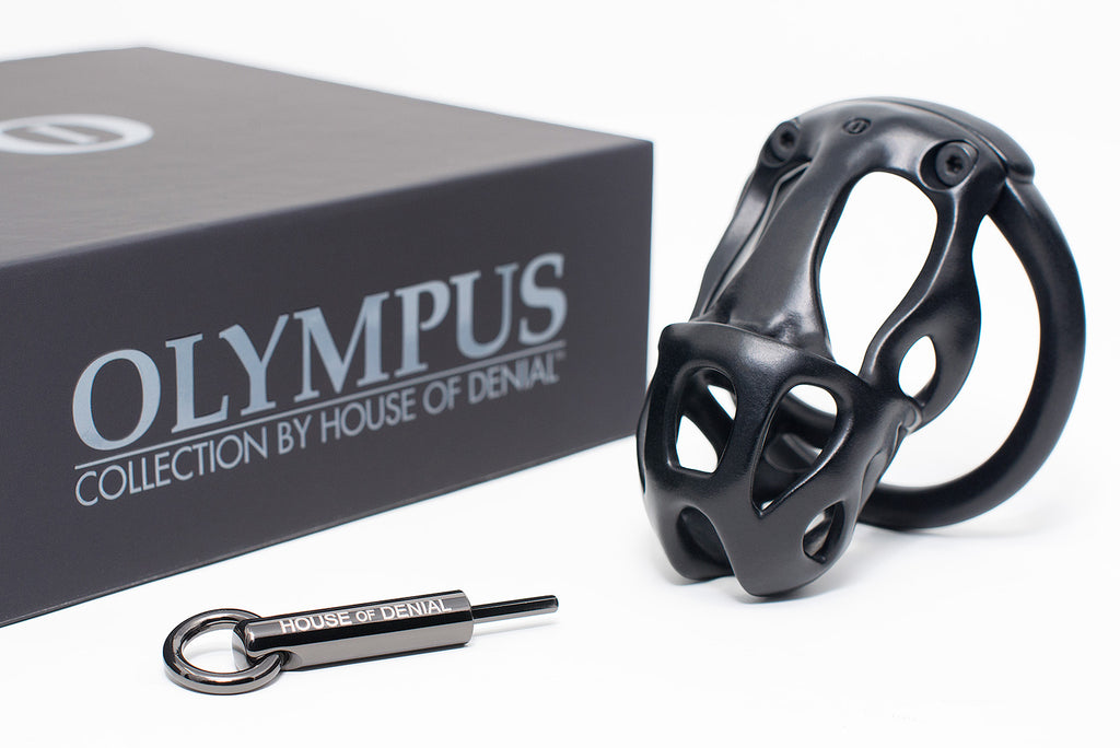 Black Hera chastity device with hexlock pendant key and Olympus storage box.